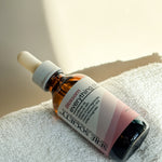 Blossom Everything Oil sitting on top of a towel